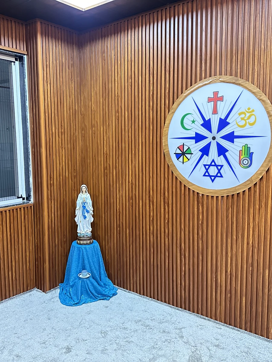 Statue of Mother Mary and the multi-religion emblem